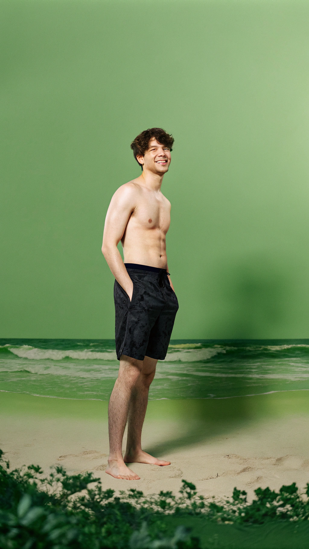 AI generated image by FLUX.1-schnell: Full body shot of a cute gay slim 20 year old boy in swimming trunks, on the beach, smiling